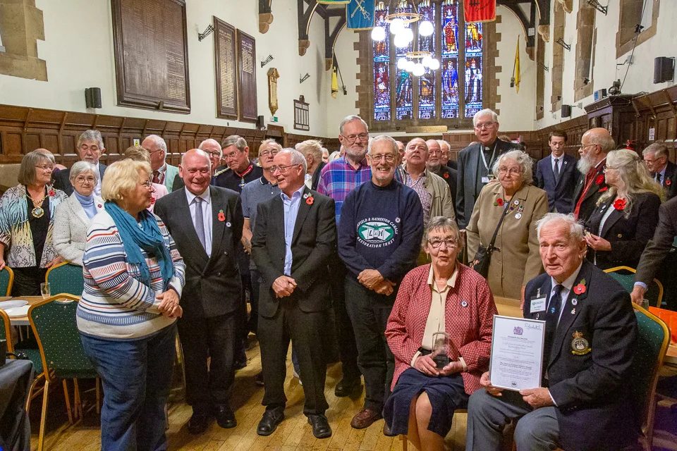 A group of people posing with a certificate