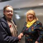 Christine Bull shaking hands with LHCRT chair Carole Mills
